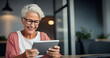 A smiling older woman embracing technology, showing how enthusiastically she uses a tablet .