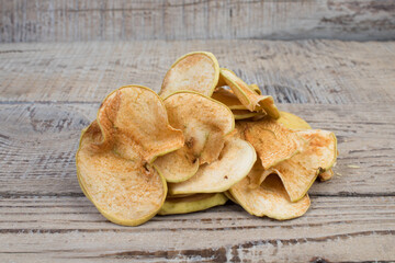 Wall Mural - Sliced, dried apples isolated on wooden background. Homemade organic apple.