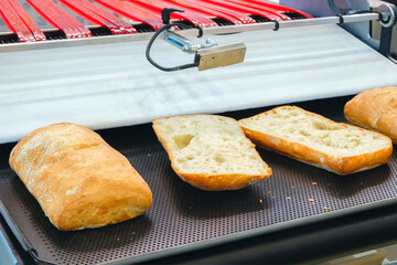 Poster - Sliced white bread in a cutting machine