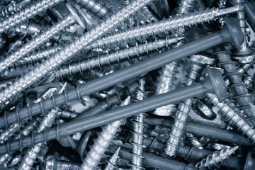 Poster - A lot of screws flat lay abstract background in blue tone