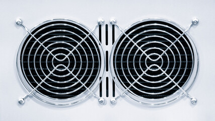 Poster - An air fan behind a metal grille installed on a modern computer AC power supply unit. Cooling the computer and its components. White background. Photo. Close-up