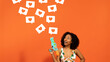 © Prostock-studio - Curious woman with water gun, heart speech bubbles on orange background, panorama