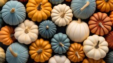 A Bunch Of Small Pumpkins Sitting On Top Of Each Other