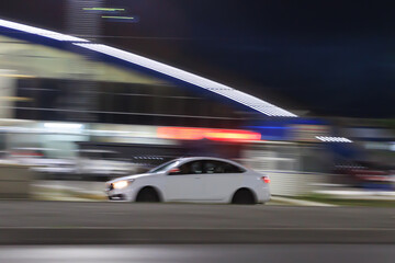 Wall Mural - car drives through the night city,