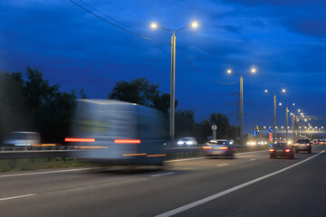 Wall Mural - car traffic in the evening on a suburban highway.