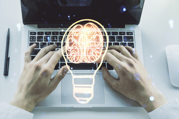 Poster - Double exposure of creative light bulb hologram with human brain and with hands typing on laptop on background, idea and brainstorming concept