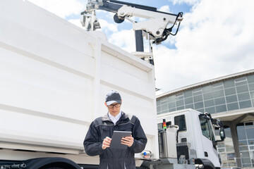 Poster - Manager with a digital tablet next to garbage truck