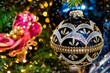 Christmas decorations close up. Christmas tree festive lights background with a blue ball. 
