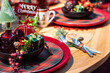 Beautiful festive Christmas table setting. Decoration with tartan for Christmas celebration. 