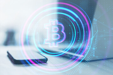 Poster - Close up of laptop and tablet with glowing round polygonal bitcoin hologram on blurry background. Online banking and cryptocurrency concept. Double exposure.
