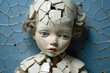 A cracked porcelain doll with missing limbs.