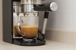 close-up of an espresso machine arm making coffee; sleepy mornings