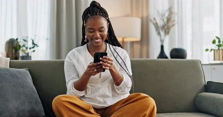 Sticker - Black woman on sofa, laughing or typing on phone for meme, social media or blog post with smile in home. Happy girl on sofa with smartphone checking email, funny website or online chat in living room