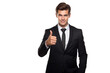 © Tepsarit - Cool looking young businessman thumbs up in black suit and tie isolated on white background.