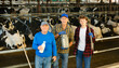 © JackF - Continuity of generations - portrait of farmers of different ages against the backdrop of a cowshed