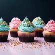 3 red velvet cupcakes with contemporary gold white and black frosting, the cupcakes are topped with beautiful elements of sugar structures, the background is a blend of blue and pink to look like unic