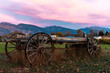 old farm wagon in Montana field blue pink sunset
