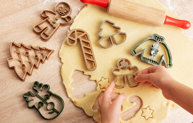 Wall Mural - Children's hands with gingerbread cookies on wooden background