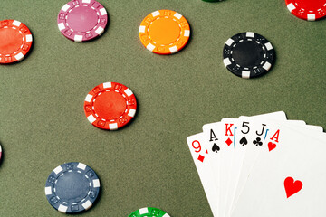 Playing cards and chips on green background