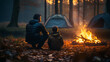 Father with son warm near campfire, drink tea and have conversation