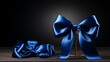 Shiny blue color satin ribbon on black background. Christmas gift, valentines day, birthday wrapping element