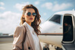 © Niks Ads - Young and successful woman standing with his privet jet