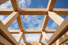 Detail Of Wooden House Frame On Sky Background. Craftsmanship And Sturdiness Into Construction. Wooden Frame Of House Without Ceilings - Decisions With Structural Sturdiness Integral To Construction.