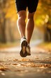 © Stavros - Jogging workout in autumn forest. Male legs close-up. Man during jogging workout in an autumn city park. Keeping fit in any age.
