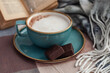coffee mug , scarf and book on the table