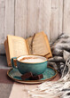 coffee mug , scarf and book on the table