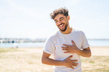 Wall Mural - Handsome Arab man at outdoors smiling a lot