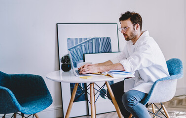 Poster - millennial male programmer working remotely at home interior with stylish design