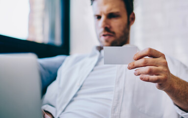 Poster - millennial hipster guy making research via netbook on blurred background