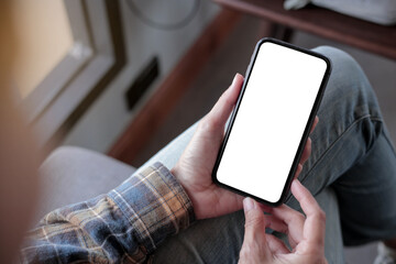 cell phone blank white screen mockup.hand holding texting using mobile on desk at office.background empty space for advertise.work people contact marketing business,technology
