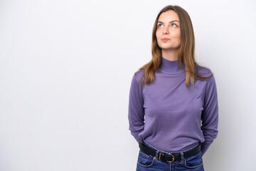 Wall Mural - Young caucasian woman isolated on white background and looking up