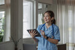 © wichayada - Portrait of a smiling female doctor holding a digital tablet wearing a medical coat and stethoscope in hospital