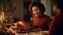 Cheerful African American Develop Lady Carving Turkey Meat Whereas Having Thanksgiving Supper With Her Family