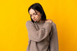 Young telemarketer woman isolated on yellow background suffering from pain in shoulder for having made an effort