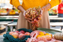 Woman Holding Bunch Of Fresh Grapes At Farmer's Market