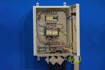 Poster - power cabinet on wall. electrical panel with open cover. power cabinet with wires and circuit breake