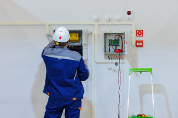 Poster - electrical cabinet repair. electrical equipment installation specialist man. repair of electrical ca