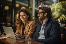 A Woman And A Man In Business Clothes Use A Laptop Workplace Coworking Portrait Manager Smiling Shows Laughter, Teamwork In A New Office.