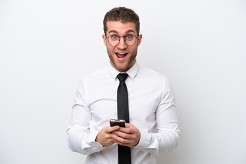 Wall Mural - Young business caucasian man isolated on white background surprised and sending a message