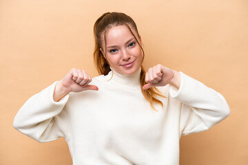 Wall Mural - Young caucasian woman isolated on beige background proud and self-satisfied