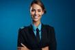Portrait of Happy Beautiful stewardess showing something on blue background