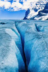 Canvas Print - Glacier with a crack by a mountain