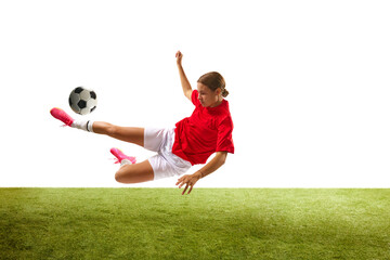 Wall Mural - Dynamic image of young girl, football player training, hitting ball in jump isolated on white background. Concept of sport, competition, action, success, motivation. Copy space for ad