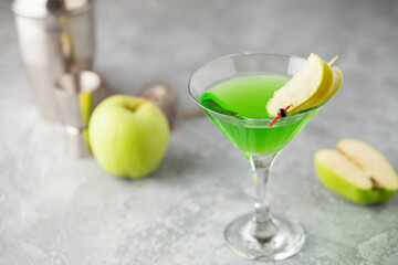 Wall Mural - Alcoholic cocktail apple martini or green sour appletini in martini glass . Bar tools.