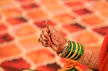 Wall Mural - Finger of indian bride. white thread around finger. Kanyadaan ceremony. Hindu wedding ceremony and rituals. Indian Wedding. Marathi Wedding