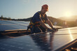 A man wearing a cap is shown working on a solar panel during sunset. The golden hue of the sun casts a warm light over the scene, highlighting the solar panels and the worker